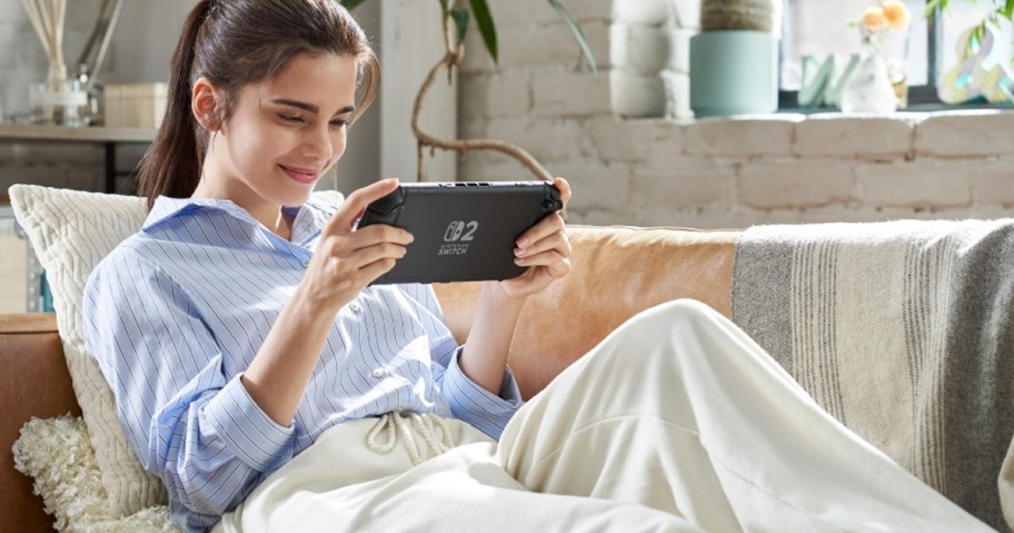 Girl playing new Nintendo Switch on sofa