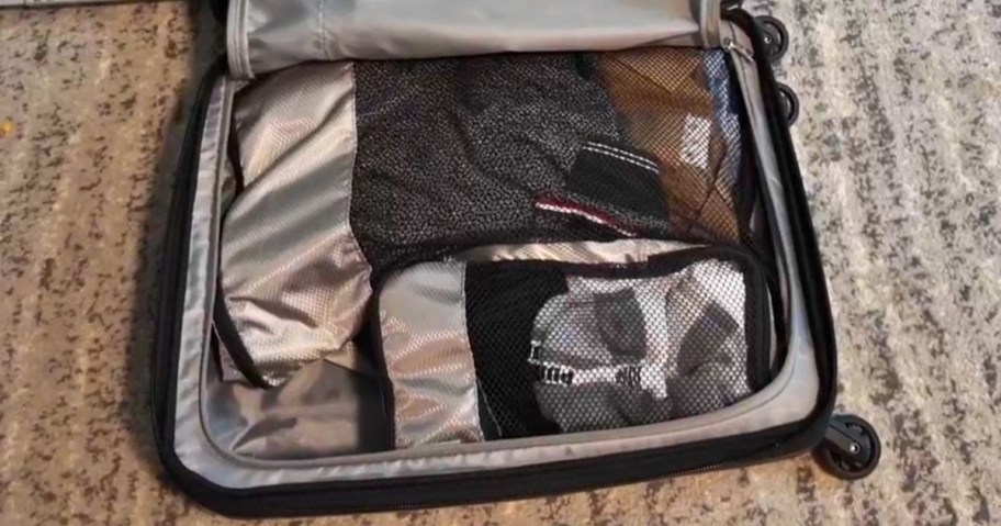 travel cubes in a suitcase on a the floor