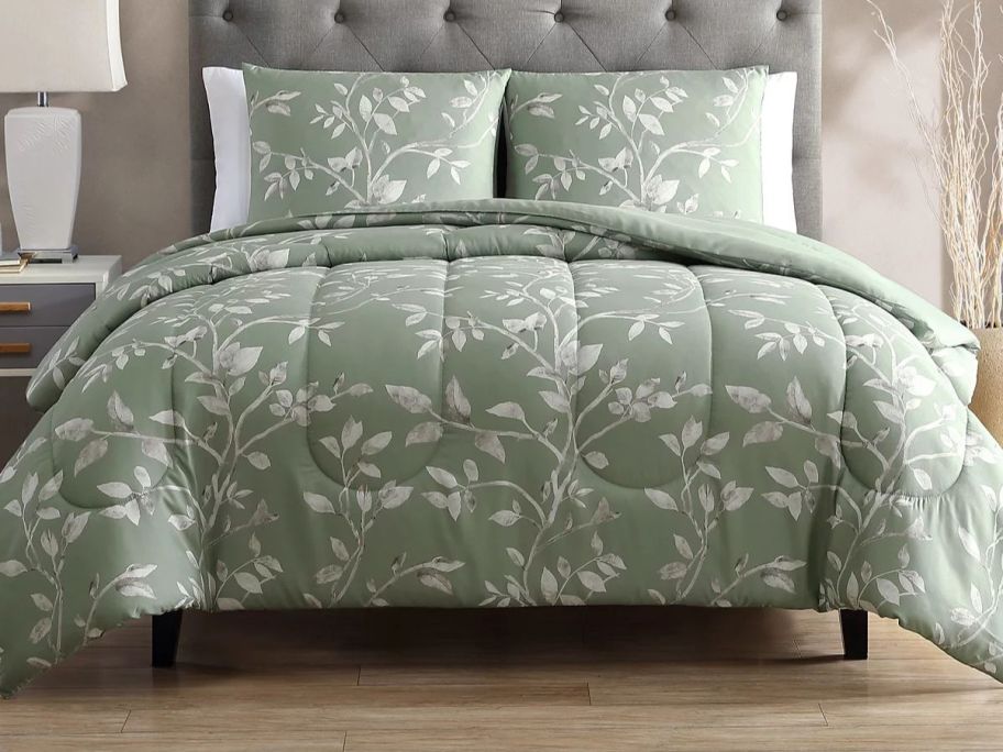 A bed with a green floral bedspread