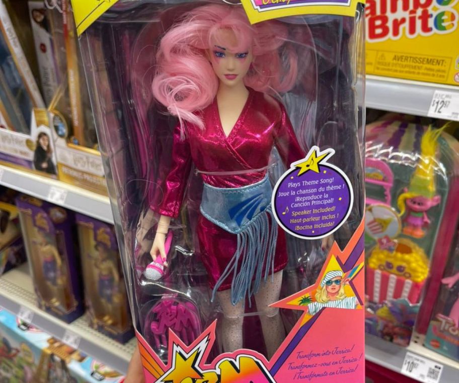 A person holding a JEM doll