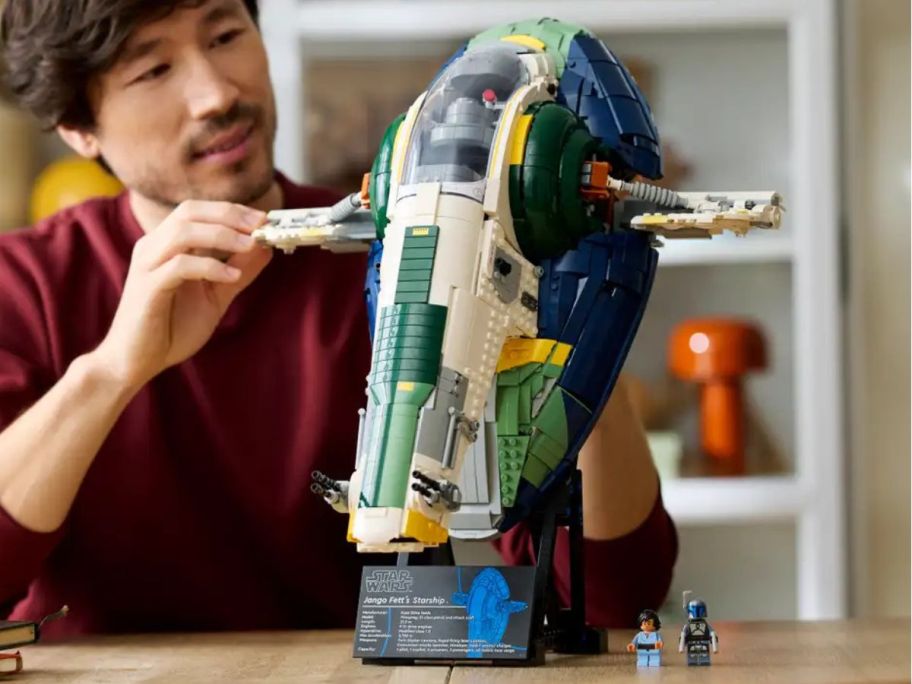 A man assembling a LEGO starship