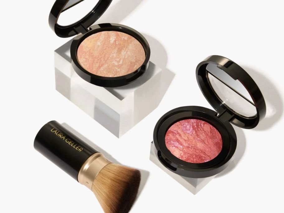 Two makeup compacts and a brush 