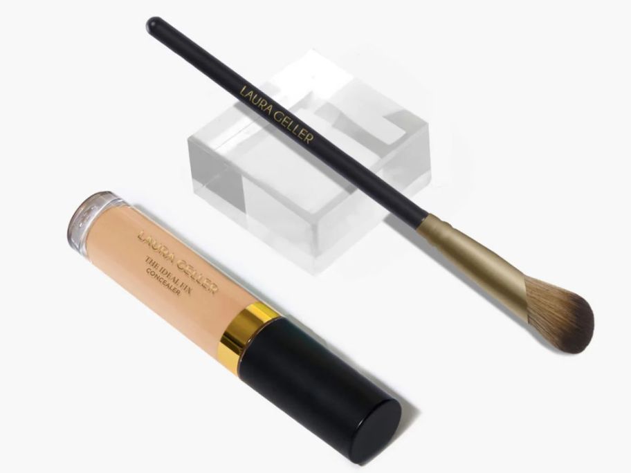A concealer tube and a makeup brush