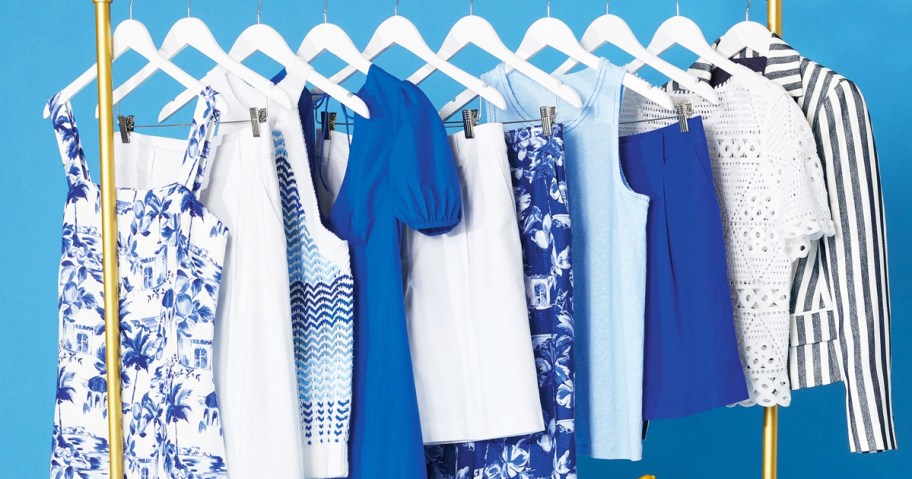 white and blue tops, skirts, and dresses on hangers on clothing rack