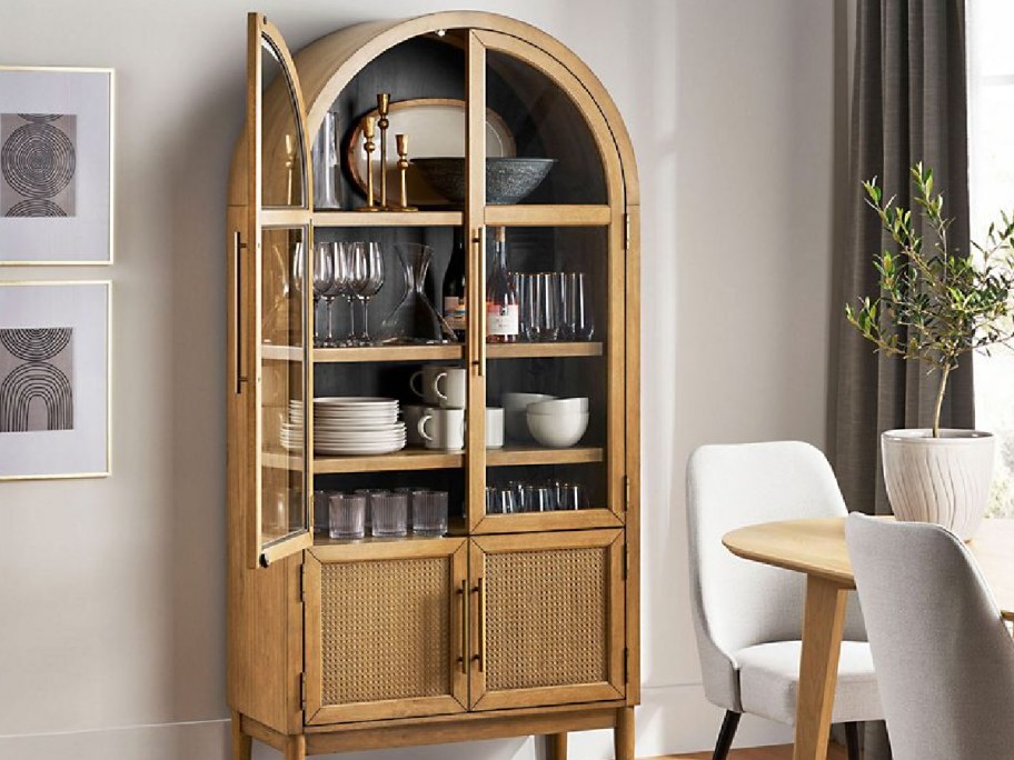 Rattan cabinet displayed with items inside of it 