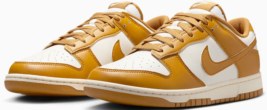 pair of golden and white colored nike sneakers