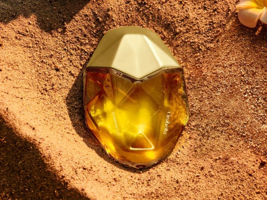 An Orebella Blooming Fire Perfume bottle in sand 