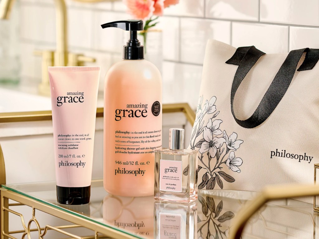 Philosophy, lotion, body wash, perfume, and tote bag on bathroom countertop