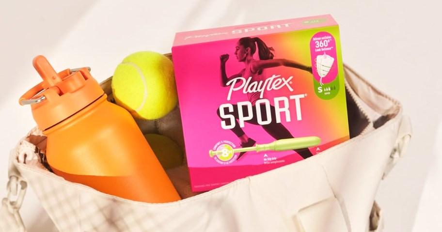 box of Playtex Sport Tampons inside gym bag with tennis ball and water bottle