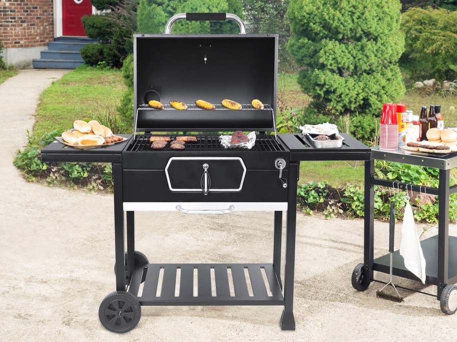 opened black charcoal grill with food inside