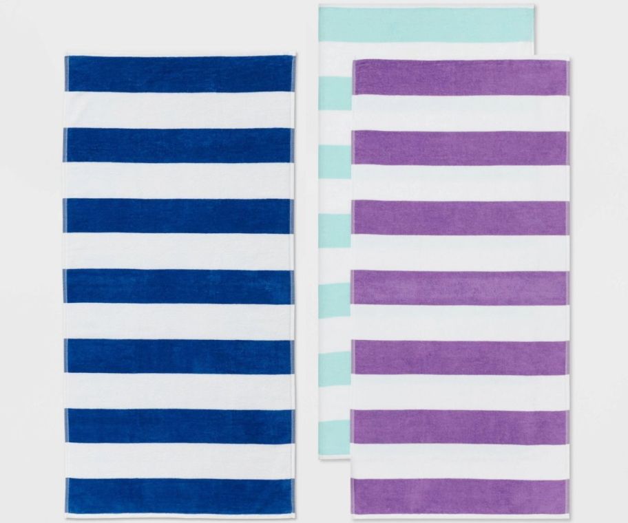striped beach towels in blue & white, aqua & white and purple & white