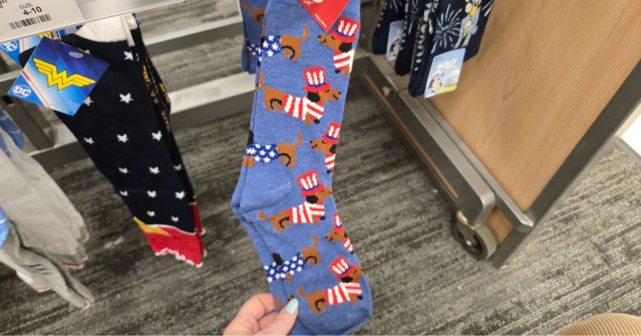 A person showing 4th of July socks at Target