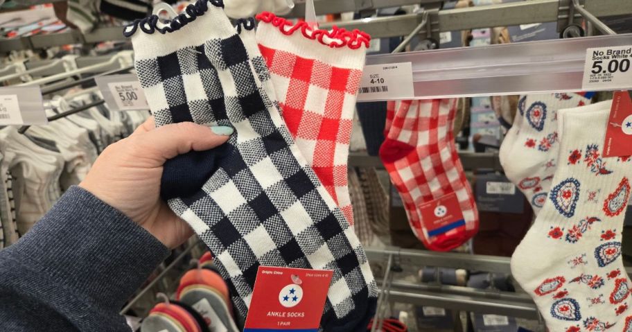 A person showing 4th of July socks at Target
