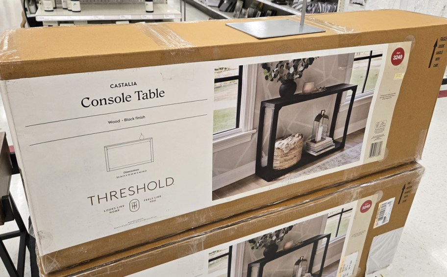 boxes for black console tables on pallet in store