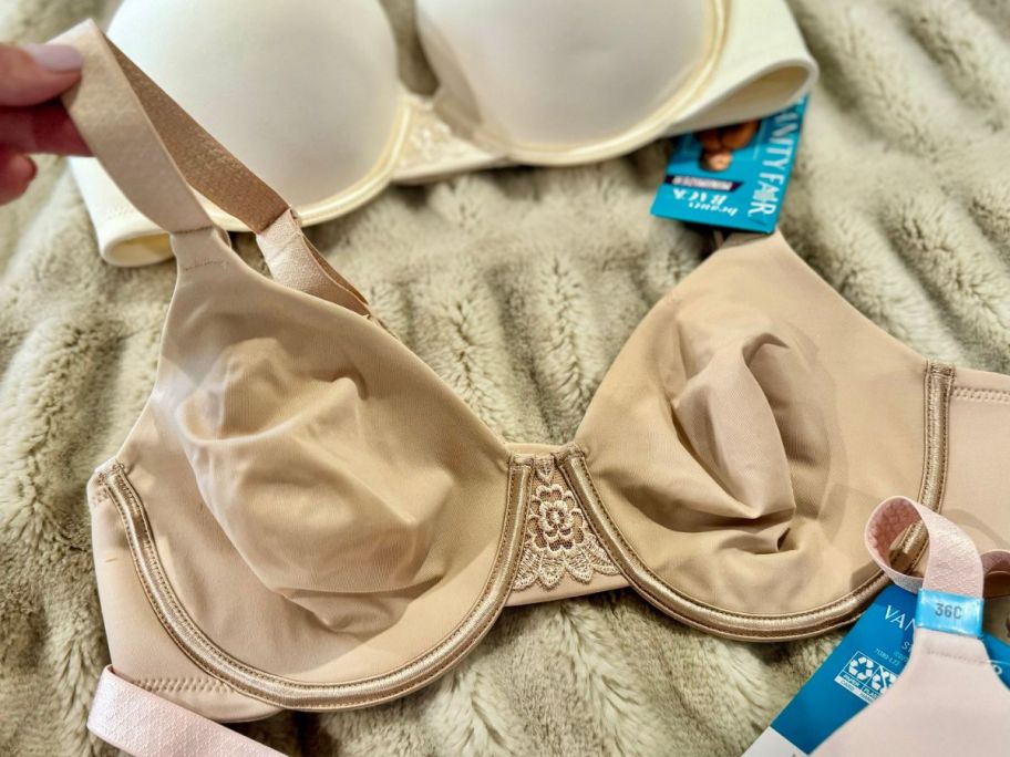 A Vanity Fair Beauty Back Full Figure Underwire Minimizer Bra on a bed