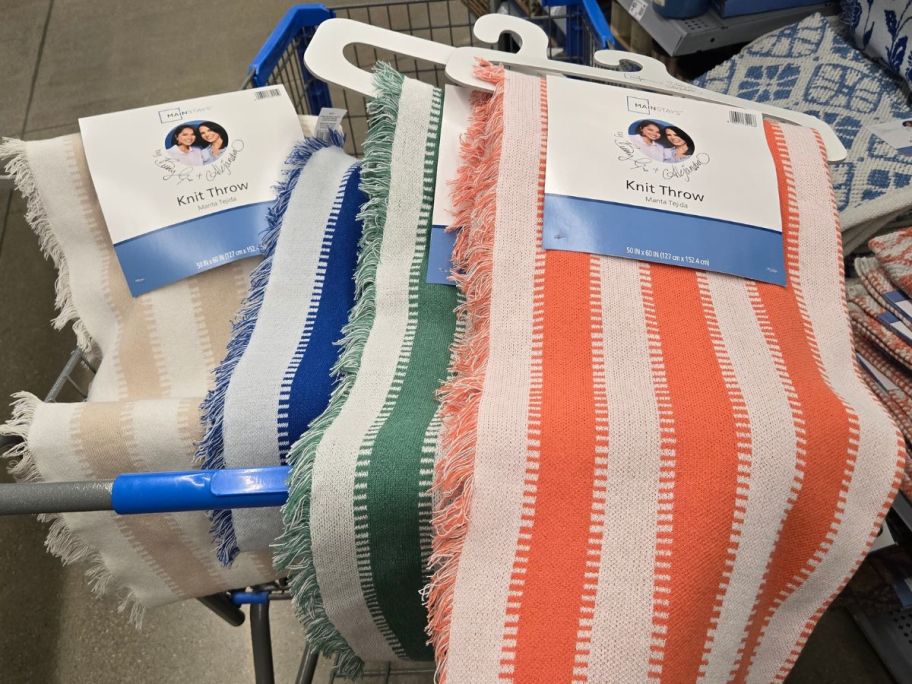 A cart filled with Mainstays by Becky G. & Alejandra Striped Tapestry Knit Throws