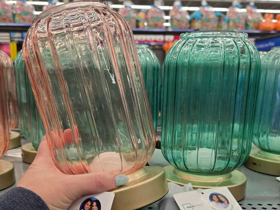 Hand holding a pink Mainstays by Becky G. & Alejandra Rechargeable Ribbed Glass Uplight
