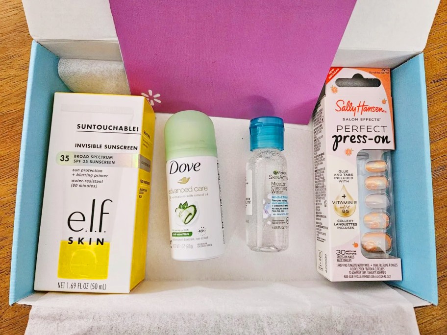 beauty box filled with dry shampoo, sunscreen, press on nails and more