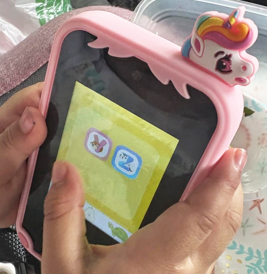 kid playing game on toy smartphone
