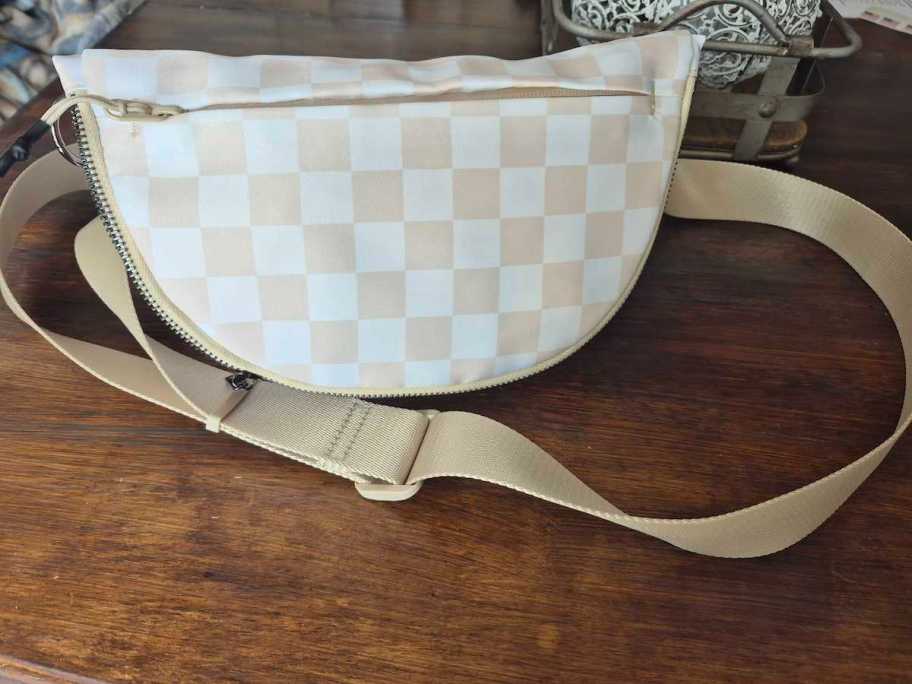checked crossbody on wood table