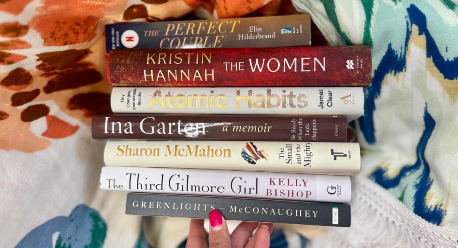 hand holding a stack of books 