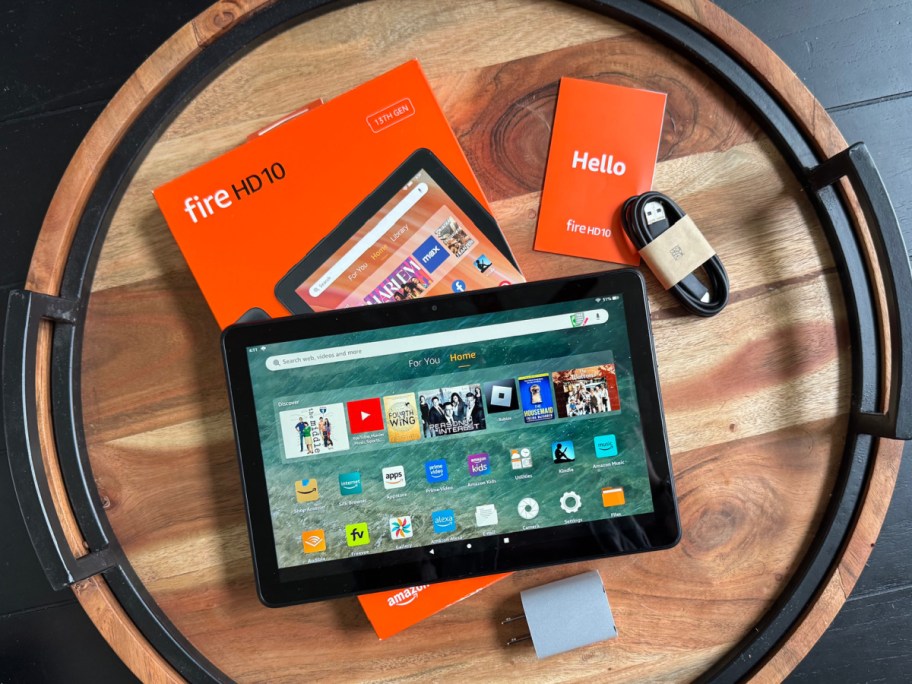 table with Amazon tablet and all items that are on top of it displayed