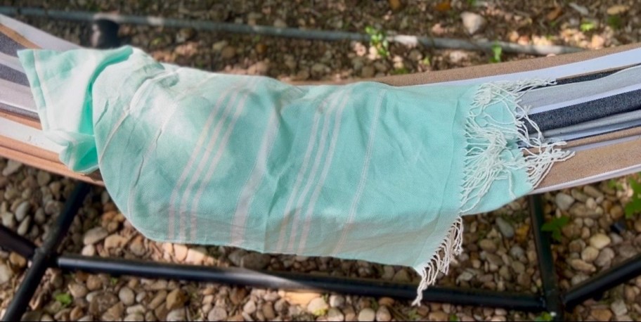 blue striped towel on hammock outside