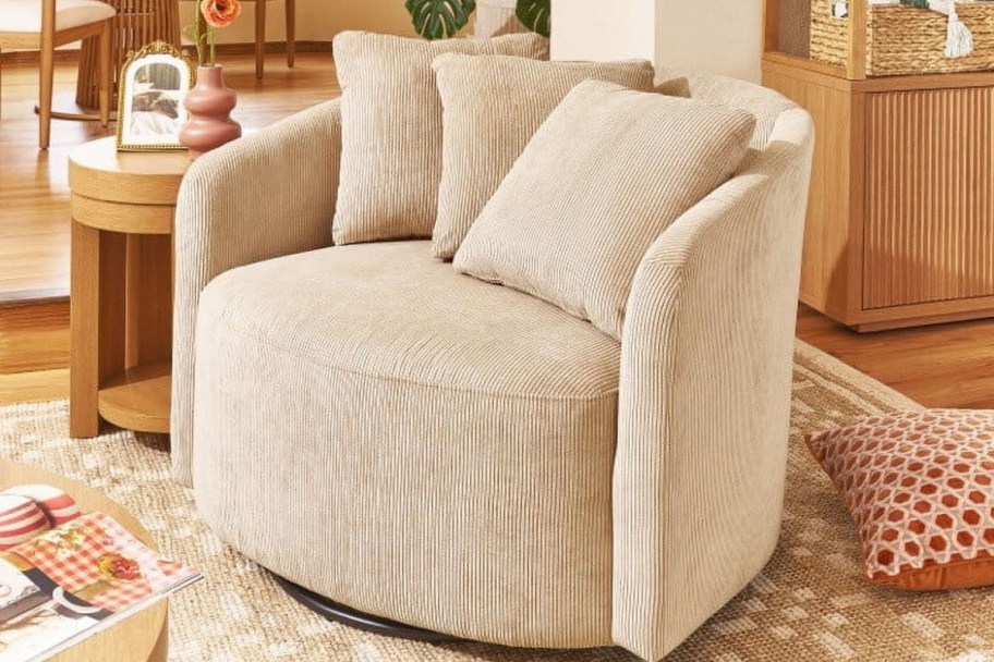 tan swivel chair with throw pillows in a living room