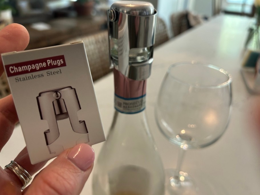 bottle of champagne with wine glass on counter