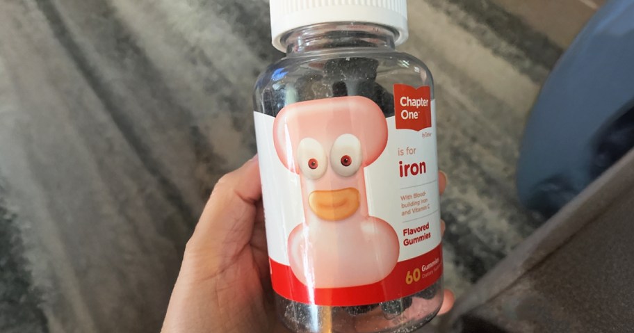 hand holding a bottle of iron gummies