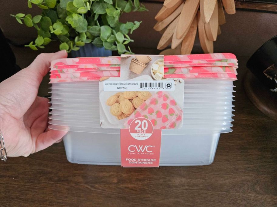 hand holding a pack of Cook With Color food storage containers with strawberry print lids