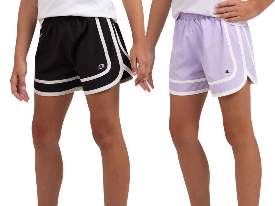 two kids wearing black and purple champion shorts