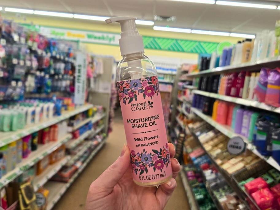 hand holding a bottle of shave oil in a store