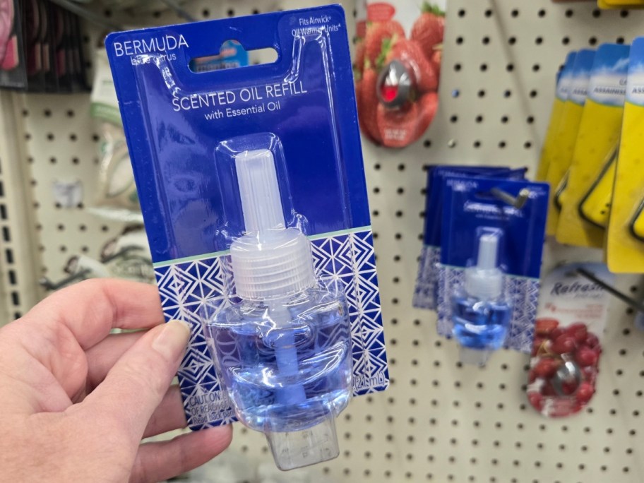 hand holding an essential oil diffuser refill