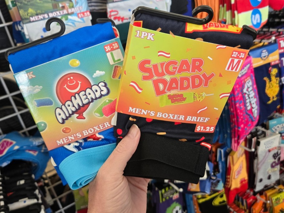 hand holding pairs of men's Air Heads and Sugar Daddy boxers