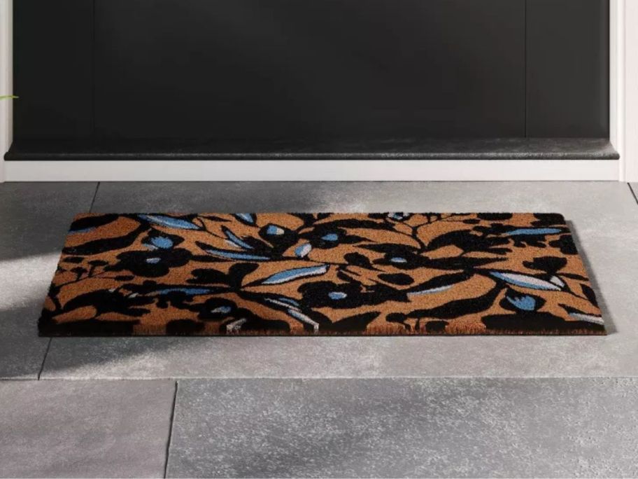 beige, blue, and black Room Essentials Floral Silhouette Doormat at doorstep