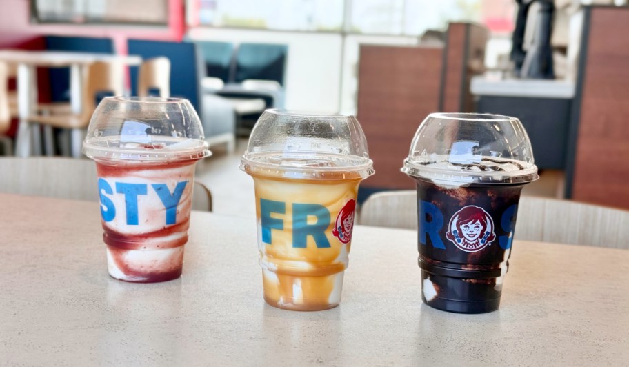 three new frosty swirls lined up on a restaurant table