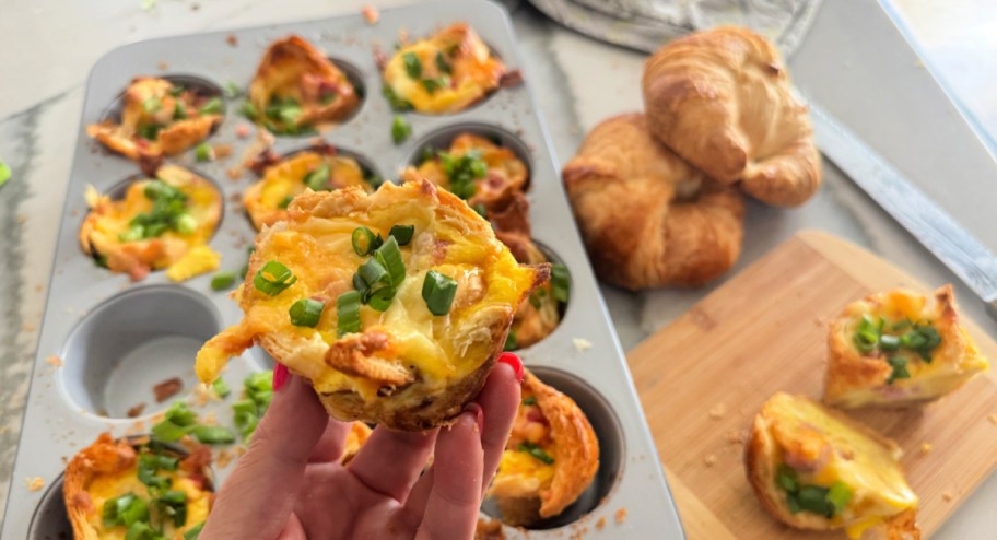 holding a croissant egg muffin cup 