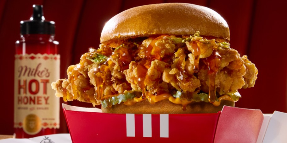 kfc mikes hot honey sandwich with bottle of honey behind it