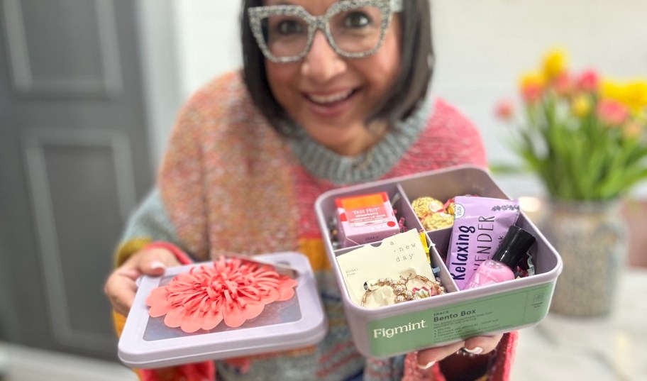 woman holding bento box filled with goodies