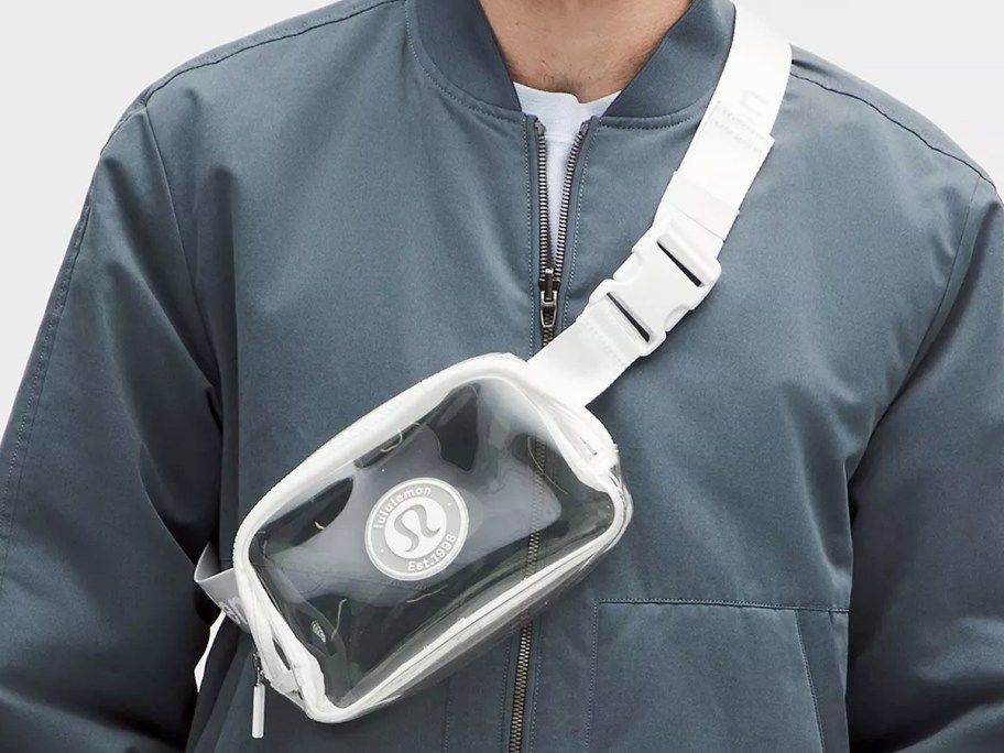 man in blue jacket with clear crossbody bag