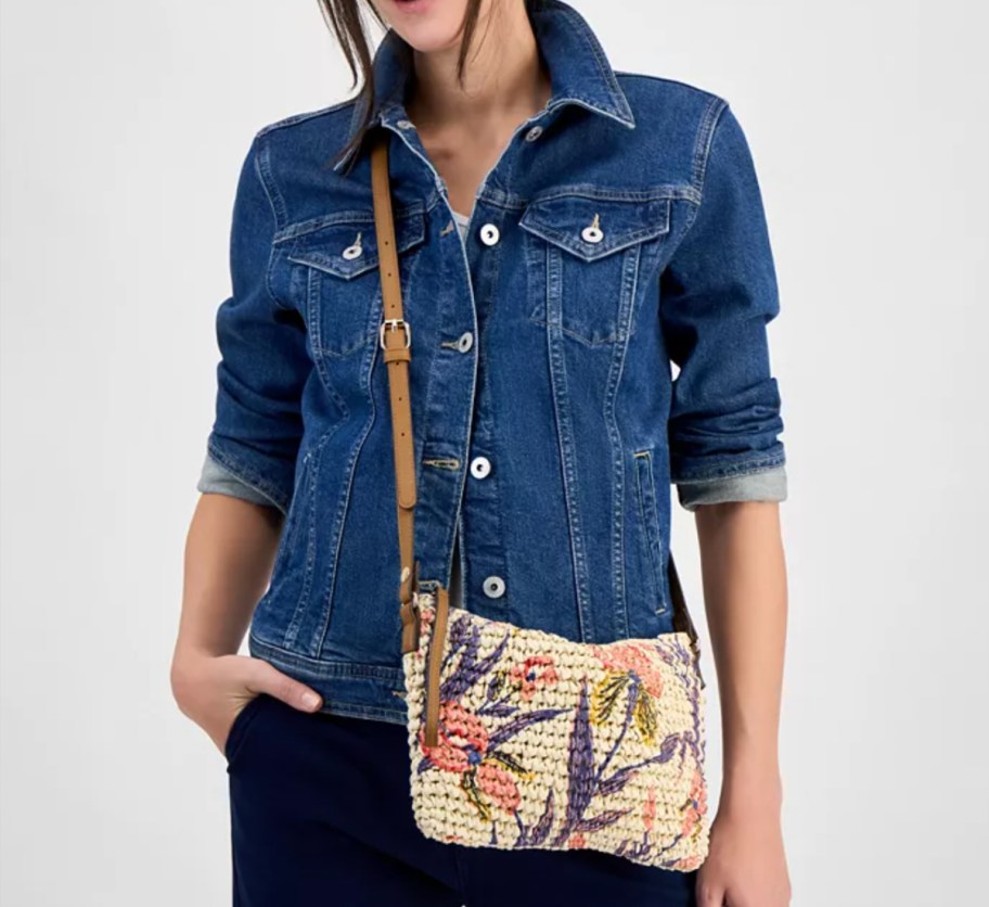 woman in jean shirt wearing floral crossbody bag
