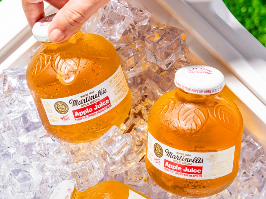 bottles of apple juice on ice
