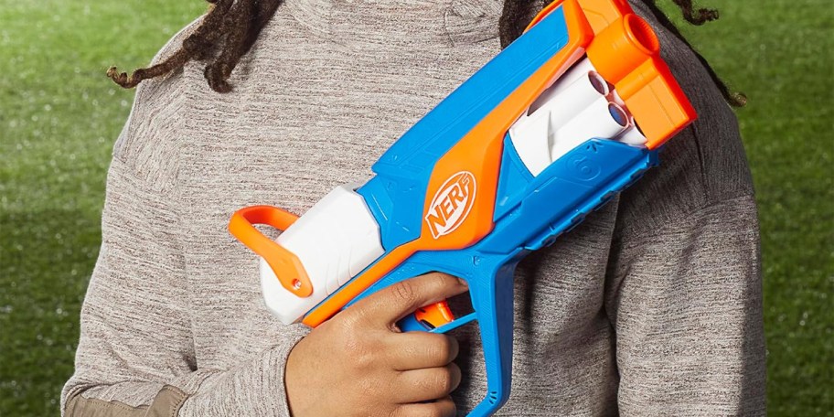 boy holding blue and orange nerf blaster 