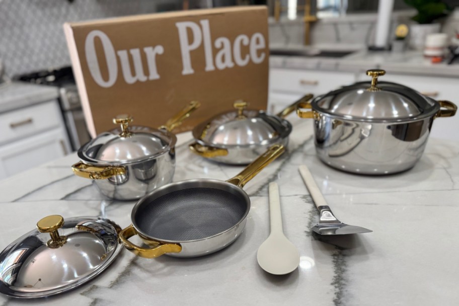 gold and titanium cookware next to our place box