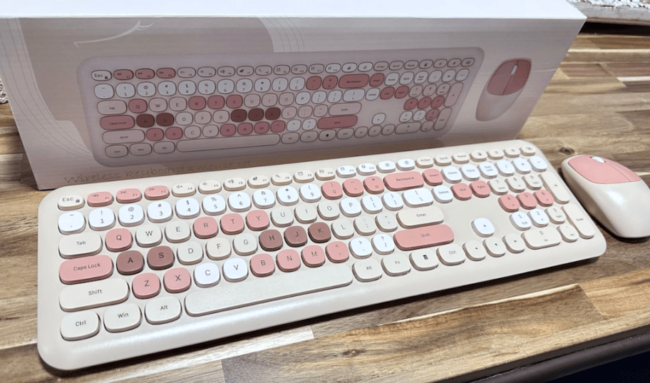 light and darker pink wireless retro keyboard and mouse on a desk