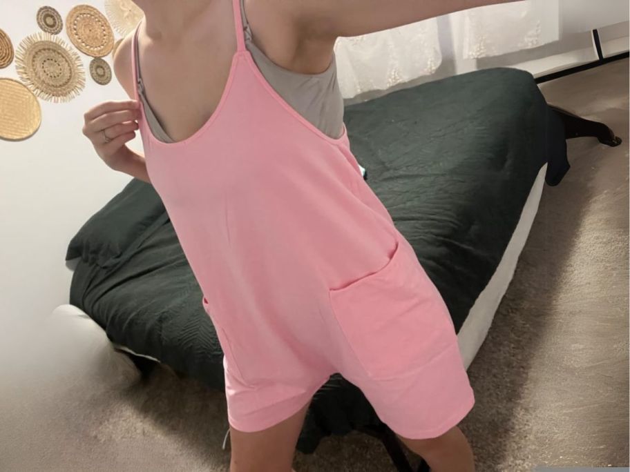 woman wearing pink romper in bedroom