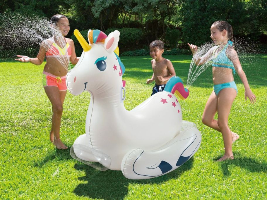 kids playing around Play Day Rock N' Spray Unicorn in yard