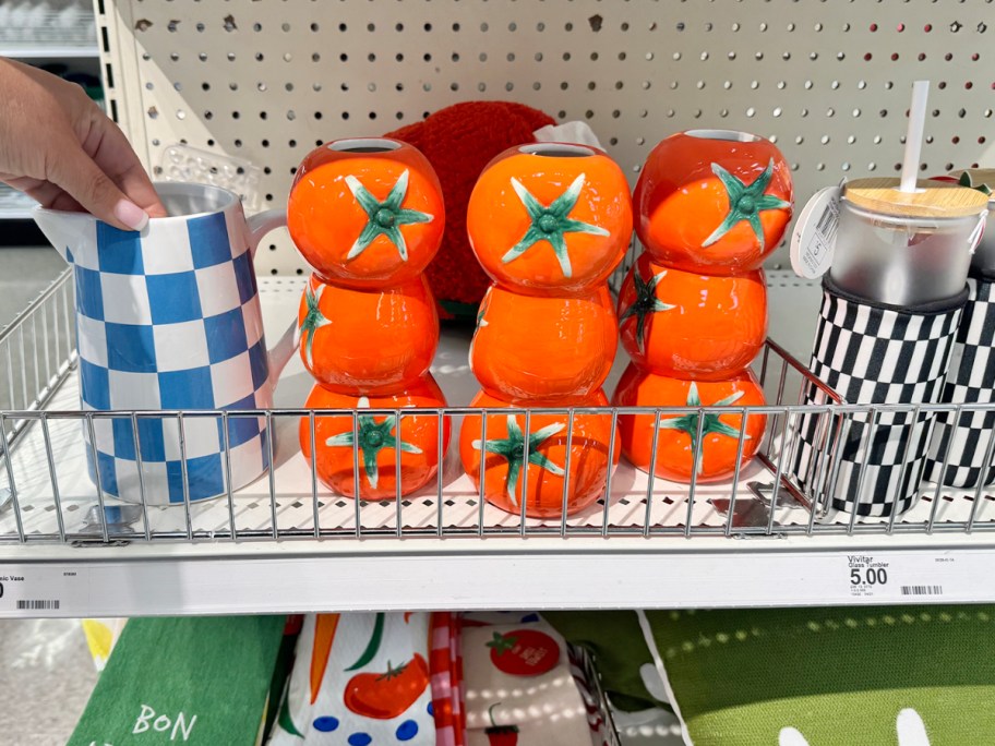 blue and white checkered vase and a stacked tomato style vase on shelf in store