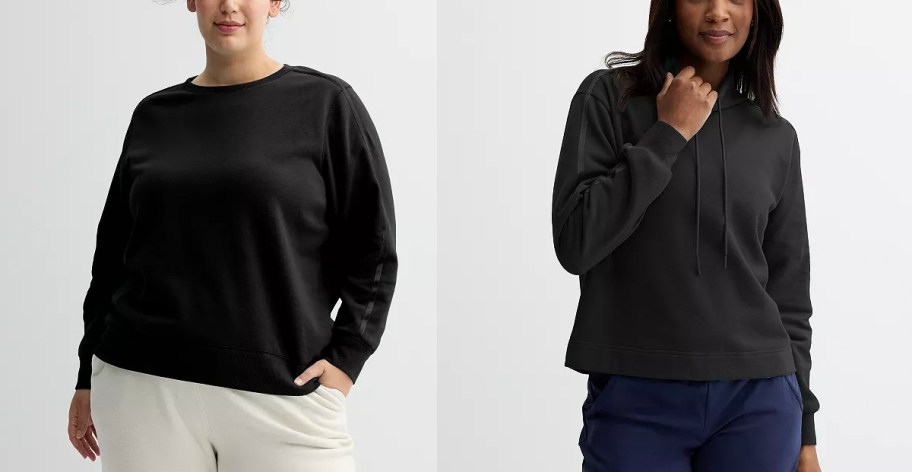 two women wearing black hoodies and sweatshirts